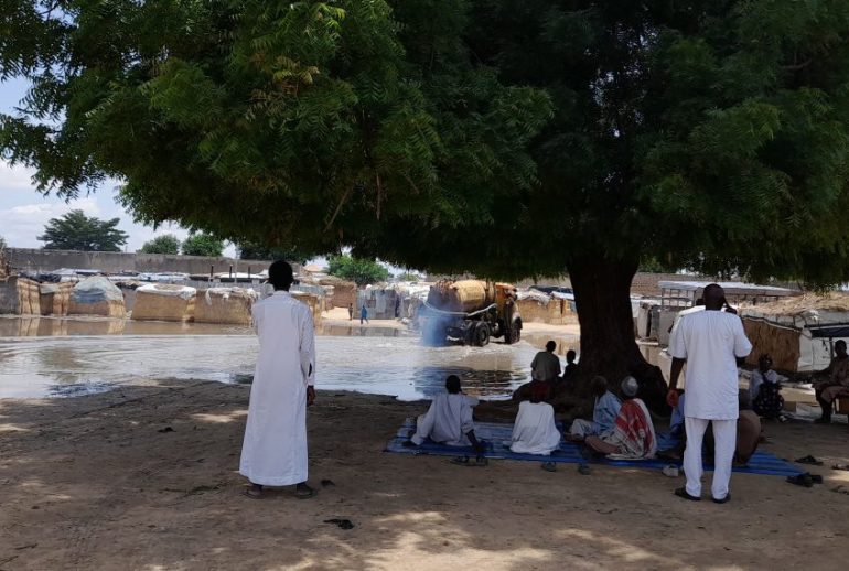 Community_members_having_a_discussion_at_Alhaji_Kassim_IDP_Camp-1140x570