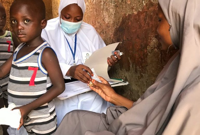 Sumayya-Ibrahim-alongside-her-twin-also-beneficiaries-if-the-ANRiN-program-recieved-her-monthly-IFA-pill-which-she-takes-one-daily-for-30-days.-1140x570